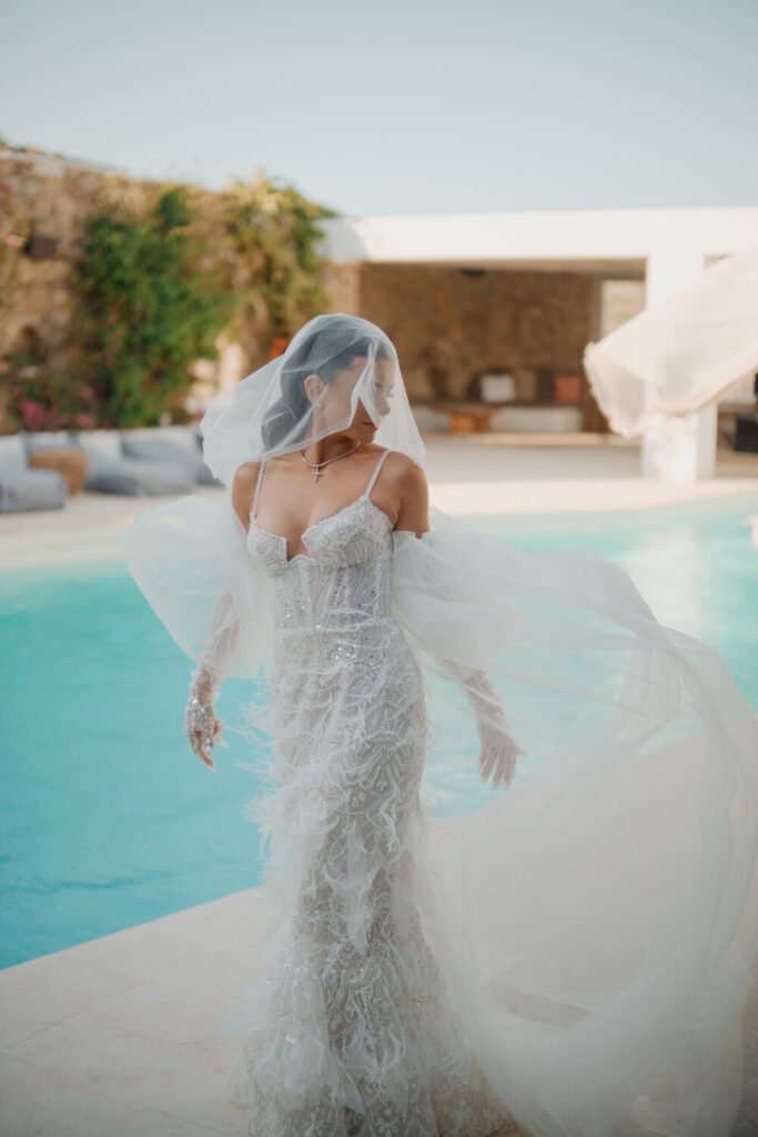 Destination Wedding in Greece bride by luxury hotel pool by Nikos Roussis Photography