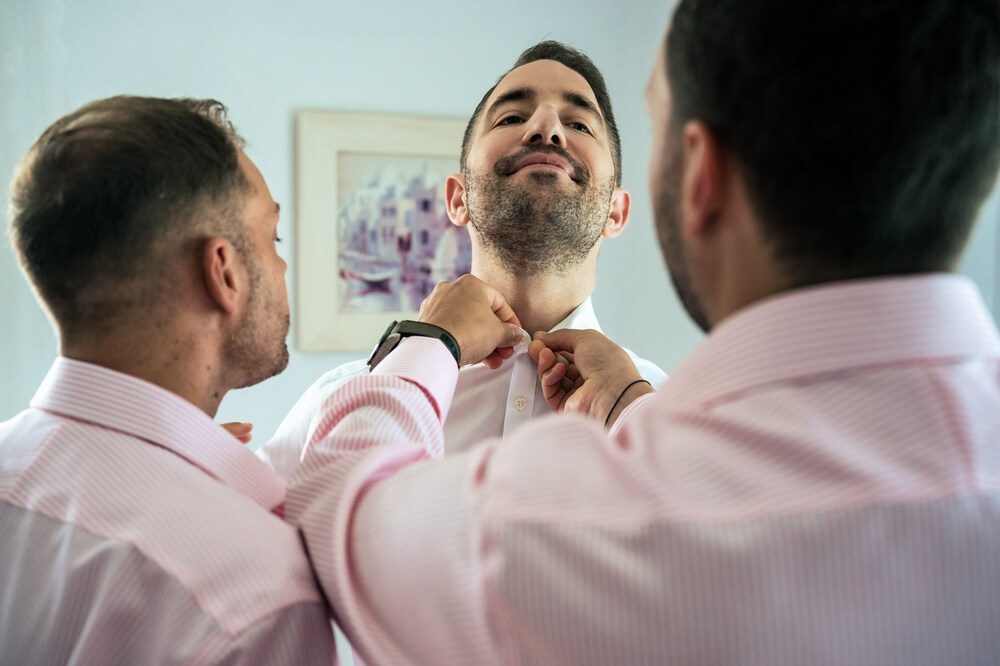 A romantic wedding in Syros - Ilia & Flavio -groom dressing accompanied by friends