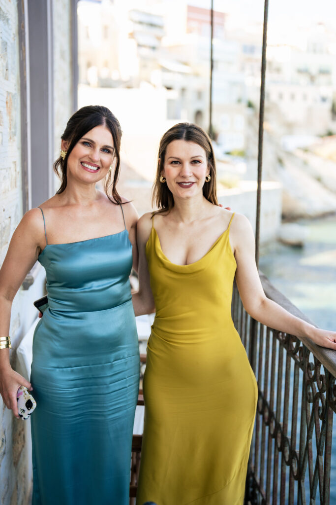 A romantic wedding in syros - bride's friends on balcony