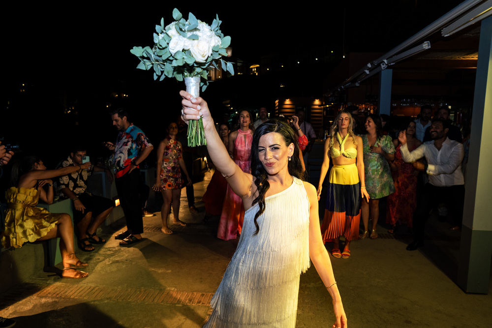 A romantic wedding in Syros - Ilia & Flavio -bride throws bouquet